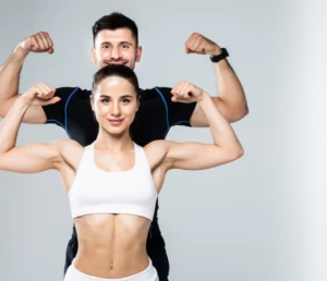 beautiful athletic couple show biceps - mobile trainers